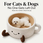 Small white dog lying in the coffee cup pet bed